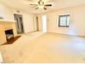 Spacious living room with a decorative fireplace and ceiling fan at 1112 N Driver St, Durham, NC 27701