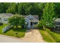 An aerial view of a quaint light blue home nestled among lush green trees in a serene neighborhood at 1138 Ricochet Dr, Raleigh, NC 27610