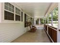 Inviting front porch features rocking chairs, wood railings, and a peaceful view of the surrounding landscape at 117 Lema Dr, Garner, NC 27529