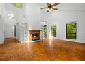 Bright living room with vaulted ceilings, fireplace, and large windows offering scenic views of the outdoors at 120 Polks Landing Rd, Chapel Hill, NC 27516