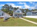Beautiful two-story home featuring a classic design, a cozy front porch, and well-maintained landscaping at 1230 S 2Nd St, Smithfield, NC 27577