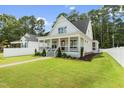 Charming two-story home with a welcoming front porch and well-manicured lawn and landscaping at 1230 S 2Nd St, Smithfield, NC 27577