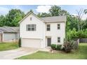Well-maintained home featuring an attached garage, mature trees, and a cozy, welcoming appearance at 157 Lynn Dr, Clayton, NC 27520