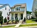 Charming two-story home with a cozy front porch, landscaped yard, and a delightful curb appeal at 1705 Main Divide Dr, Wake Forest, NC 27587