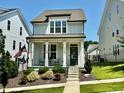 Charming two-story home with a cozy front porch, landscaped yard, and a delightful curb appeal at 1705 Main Divide Dr, Wake Forest, NC 27587