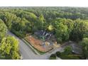 Aerial view of modern home featuring brick and green sheathing, located in lush neighborhood at 1925 Hunting Ridge Rd, Raleigh, NC 27615