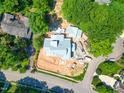 Bird's-eye view of a house in the process of being built, situated in a neighborhood surrounded by trees at 1925 Hunting Ridge Rd, Raleigh, NC 27615