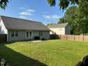 Spacious backyard with a well maintained lawn and a wood fence at 201 Joe Gibson Dr, Gibsonville, NC 27249