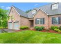 Beautiful brick home featuring an attached two-car garage and lush landscaping at 2012 Muirfield Ct, Elon, NC 27244