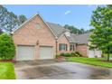 Expansive brick home with a two-car garage and a meticulously maintained lawn at 2012 Muirfield Ct, Elon, NC 27244