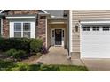 Inviting home entrance with stone accents, green landscaping, and a modern front door at 2117 Crockett Ridge Rd, Fuquay Varina, NC 27526