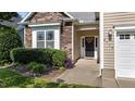 Close-up of home featuring stone facade, neat landscaping, and a welcoming front door at 2117 Crockett Ridge Rd, Fuquay Varina, NC 27526