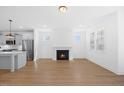 Bright living area with a fireplace, open to the kitchen with stainless steel appliances at 212 Aubey Ln, Wake Forest, NC 27587