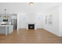 Open-concept living space with hardwood floors, cozy fireplace, and modern finishes at 212 Aubey Ln, Wake Forest, NC 27587