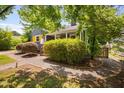 Quaint home with gray siding, yellow shutter accents, and manicured landscaping at 218 Lafayette Rd, Raleigh, NC 27604