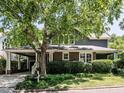 Charming brick home with a large tree in front and a covered carport at 2212 Oxford Hills Dr, Raleigh, NC 27608