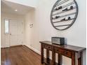Inviting foyer with hardwood floors and a decorative wine rack above a wooden console table at 2212 Oxford Hills Dr, Raleigh, NC 27608