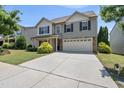 Attractive two-story home with a two-car garage, nicely landscaped front yard, and sidewalk at 2412 Averon Dr, Fuquay Varina, NC 27526