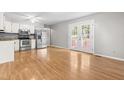 Bright kitchen featuring stainless steel appliances, white cabinetry, and access to outdoor space through stylish French doors at 250 Dixon Rd, Graham, NC 27253