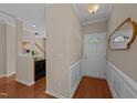 Welcoming foyer with hardwood floors, neutral paint, white door, and stairway access at 2821 Corbett Grove Dr, Raleigh, NC 27616