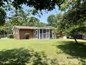 Beautiful backyard with green grass and a screened-in porch at 2909 Sprucewood Dr, Durham, NC 27707