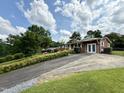 Charming single-story home with well-manicured lawn, featuring vibrant shrubbery and a driveway at 2909 Sprucewood Dr, Durham, NC 27707