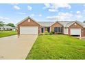 Beautiful single-story brick house with a lush green lawn and inviting curb appeal at 3027 Maple # T1, Burlington, NC 27215