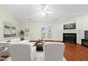 Bright living room with a fireplace, ceiling fan, hardwood floors, and double doors to the exterior at 3027 Maple # T1, Burlington, NC 27215