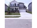 Beautiful two-story home with an attached garage, neatly landscaped lawn, and attractive gray siding at 3500 Bailey Lake Dr, Fuquay Varina, NC 27526