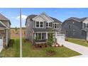 Well-maintained home with gray siding, white trim, two-car garage, and a cozy, landscaped front yard at 3500 Bailey Lake Dr, Fuquay Varina, NC 27526