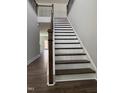 Elegant staircase with wooden handrail and white risers, leading to the upper level of the home at 3500 Bailey Lake Dr, Fuquay Varina, NC 27526