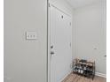 Entryway featuring light grey wall, dark laminate flooring, and shoe rack at 405 Gooseneck Dr # B6, Cary, NC 27513