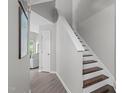 Hallway view with stairway, gray walls and laminate floor at 405 Gooseneck Dr # B6, Cary, NC 27513