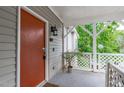 Exterior porch featuring seating area, privacy lattice, and painted front door at 405 Gooseneck Dr # B6, Cary, NC 27513