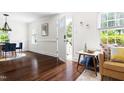 Bright living room featuring hardwood floors, an open entrance, and neutral walls at 407A Edward St, Durham, NC 27701
