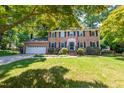 Charming two-story brick home with attached garage and a lush, landscaped front yard at 4200 Marvin Pl, Raleigh, NC 27609