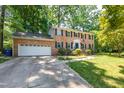 Charming two-story brick home with attached garage and a lush, landscaped front yard at 4200 Marvin Pl, Raleigh, NC 27609