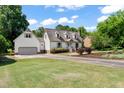 View of the home's exterior featuring a long driveway and attached garage at 4720 Cedarfield Dr, Raleigh, NC 27606