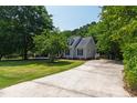 Charming home with a long driveway, well-maintained lawn, mature trees, and classic architectural details at 5413 Lower Creek Ct, Apex, NC 27539