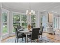 Cozy dining area with bay windows offering lovely backyard views, chandelier, and inviting seating at 6004 Brass Tack Ct, Fuquay Varina, NC 27526