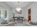 Bright office with decorative chandelier, modern furniture, and large window, perfect for a workspace at 6004 Brass Tack Ct, Fuquay Varina, NC 27526