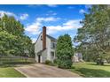 Two-story home with a brick chimney, and long driveway at 6221 Winter Spring Dr, Wake Forest, NC 27587
