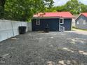 Spacious gravel backyard with white fence providing ample parking and outdoor space at 713 Champion St, Henderson, NC 27536