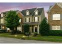 Exterior view of home at twilight showcasing a two-story facade and manicured lawn at 732 Keystone Park Dr, Morrisville, NC 27560