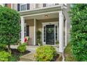 Inviting front porch features classic columns and a welcoming entrance with a wreath at 732 Keystone Park Dr, Morrisville, NC 27560