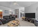 Spacious living room featuring sleek furniture, neutral colors, and a seamless flow to the kitchen at 7605 Pats Branch Dr, Raleigh, NC 27612