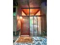 Close-up of the front door, featuring a modern design, wood accents, and glass panels for natural light at 808 Indian Springs Rd, Chapel Hill, NC 27514