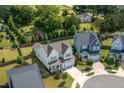 Aerial view of the home showcasing the backyard, mature trees, and neighborhood at 857 Mill Station Ln, Wendell, NC 27591