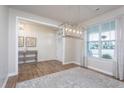 Formal entryway featuring hardwood floors, a modern light fixture, and ample natural light at 857 Mill Station Ln, Wendell, NC 27591