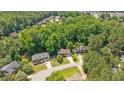 An aerial view shows well-maintained homes surrounded by dense trees in a quiet, residential neighborhood at 904 Oldwyck Dr, Fuquay Varina, NC 27526